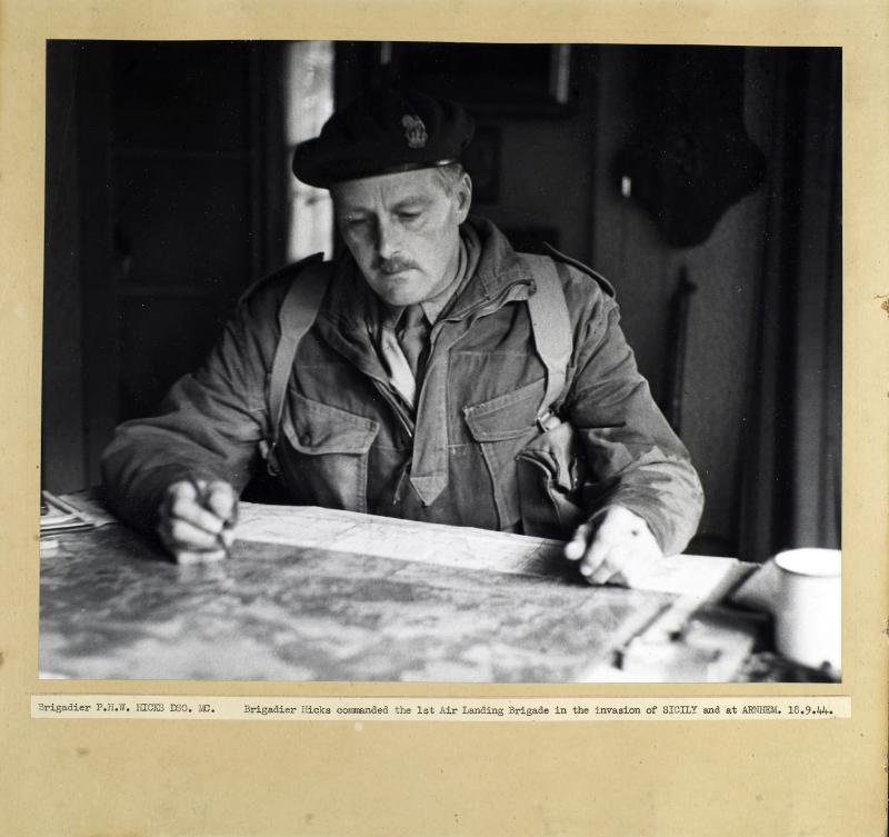 Brigadier Hicks sits studying a map
