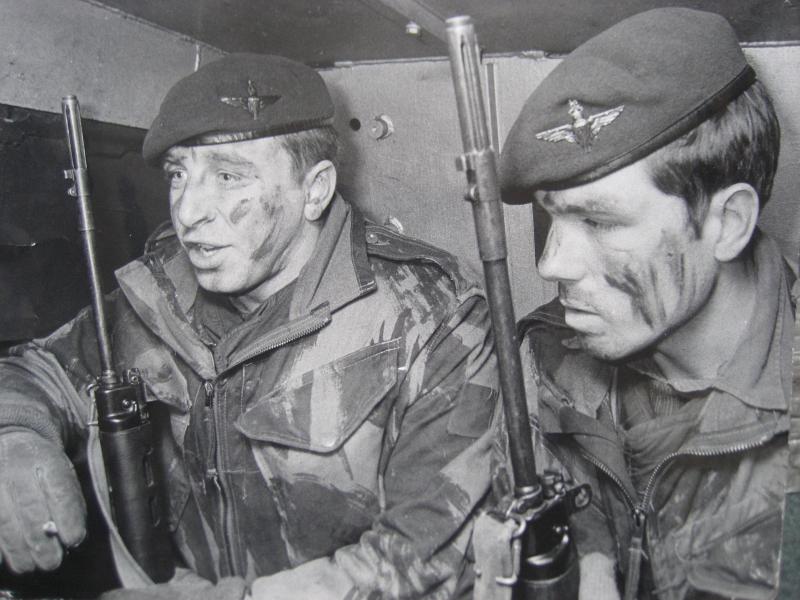 Two armed paratroopers on vehicle patrol.