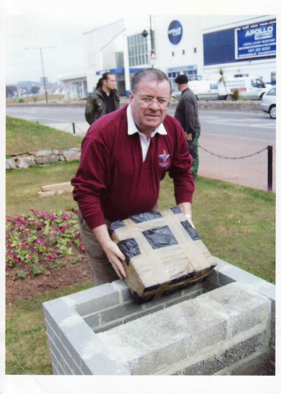 Andy Welsh MM placing a time capsule in the  Paignton Memorial