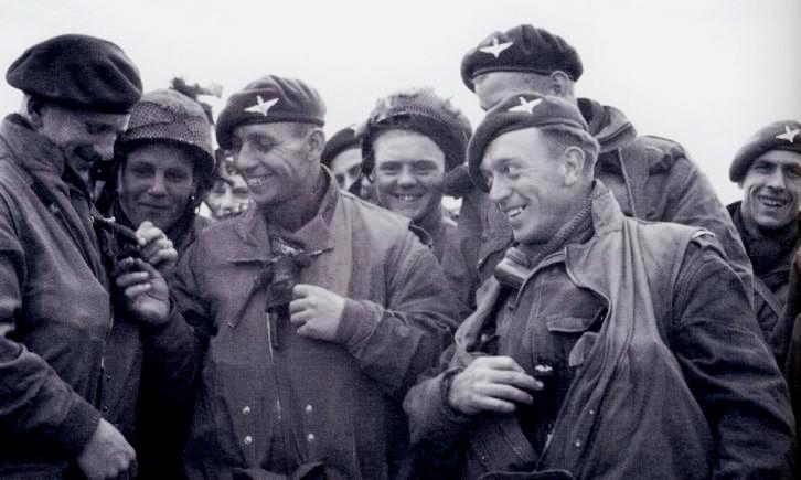 Paratroopers of 6th Airborne Division check each others jumping gear prior D-Day, June 1944