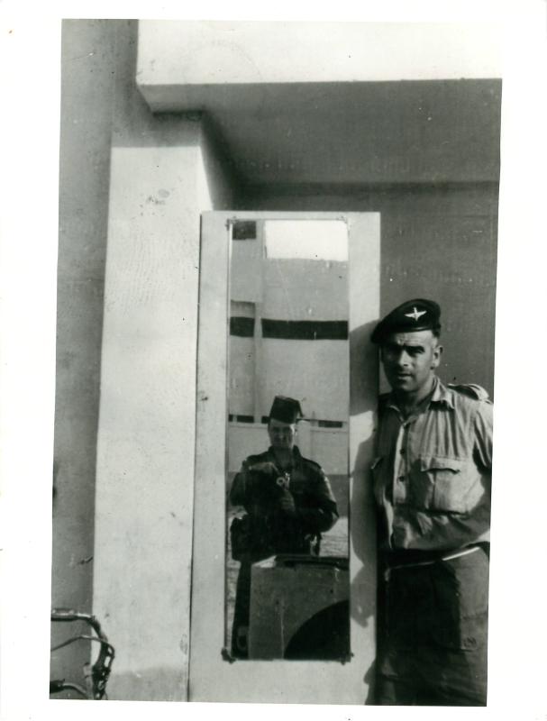 Two paratroopers pose with a mirror in a Port Said flat.