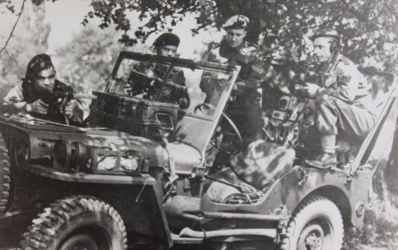 Men of 2 Forward Observation Unit RA pose with their jeep