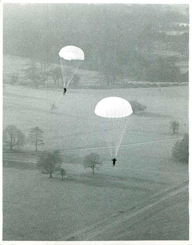 Parachute troops in air after a training jump.