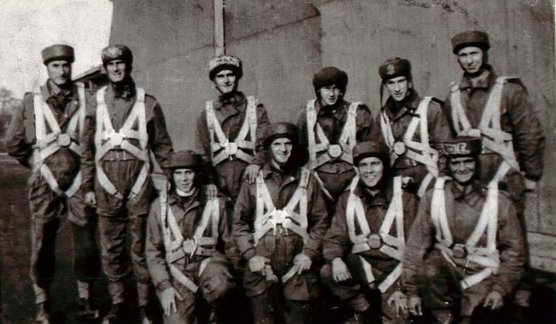 A Parachute course stick photographed during the early parachute training days with their harnesses and headwear on.