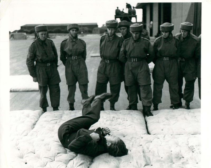Very early shot of an instructor demonstrating the parachute roll to recruits at Ringway.
