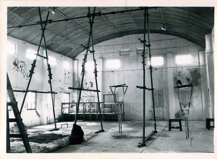 Shot of a parachute training hangar filled with swing harnesses and other equipment.