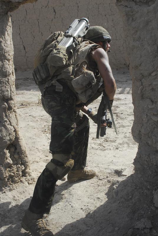 Para edges through a compound on a patrol, Afghanistan, 2008
