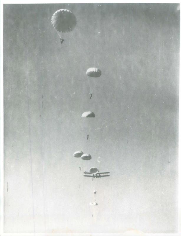 A complete stick of training parachutists having exited Vickers Valencia aircraft as seen from the drop zone.