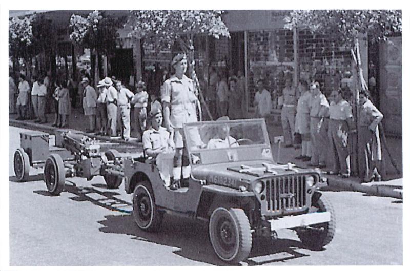 33rd Airborne Lt Reg RA jeep during King's Birthday Parade, Kingsway, Haifa, Palestine, 1947.