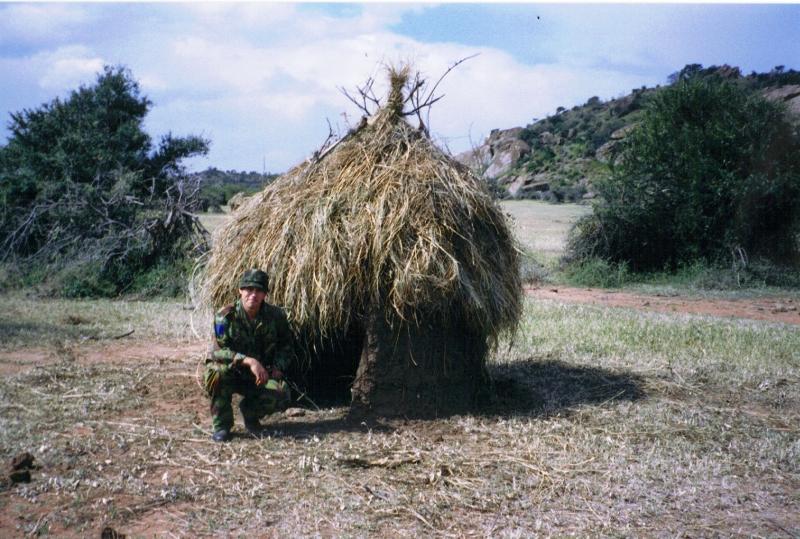 Mark Magreehan beside a hut on an Impala farm, Kenya