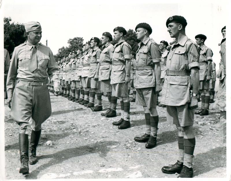 General Eisenhower walks down a line of paratroopers to thanks them for their part in Operation Torch.
