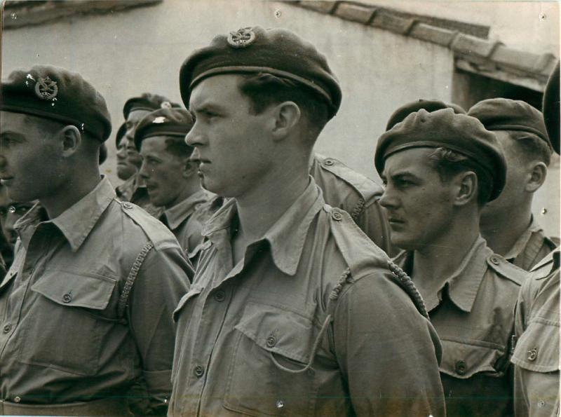 Men of 2nd Parachute Battalion listen intently to General Eisenhower.