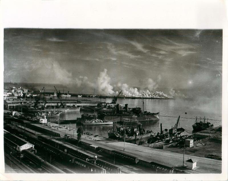 A heavy smoke screen is created to protect Allied shipping in Algiers Harbour.