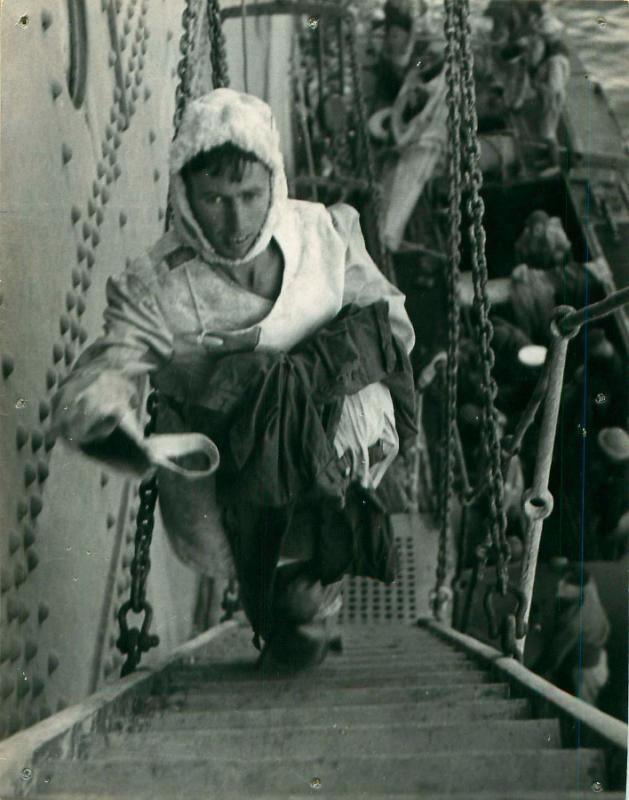 A wounded L/Cpl Blaycock walks up some ship stairs. He is a survivor of the torpedoed SS Strathallan. 