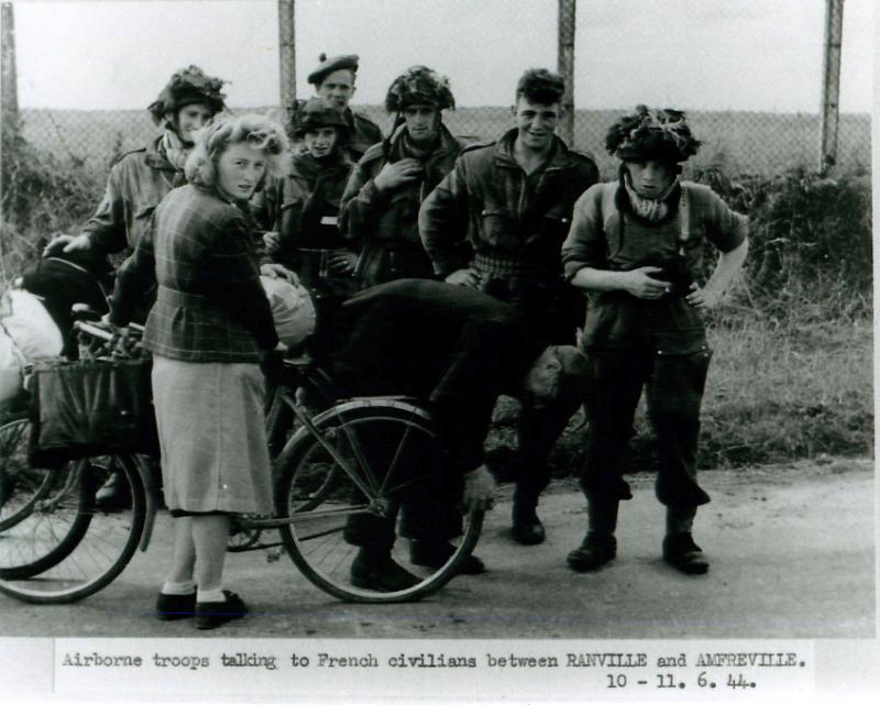 Airborne troops talk to French civilians between Ranville and Amfreville.