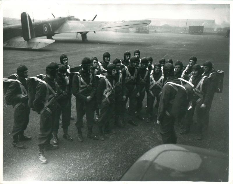 Equipped troops are briefed prior to training jumps from a Whitley aircraft.
