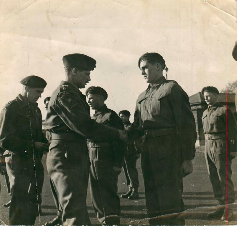 Men receive their parachute wings in a presentation on successful completion of their jump training.