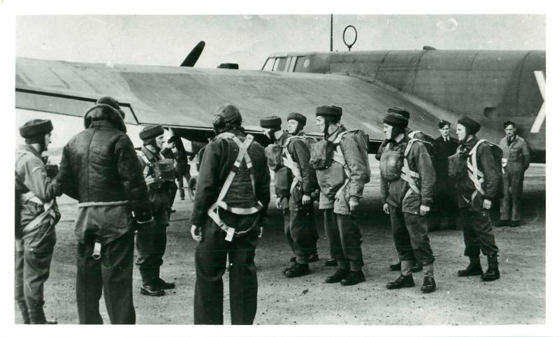 Numbering off of sticks prior to emplaning Whitley aircraft. Aircraft crew look on.