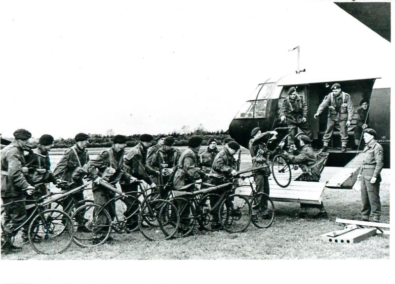Airborne troops load bikes into a glider for Normandy landing.